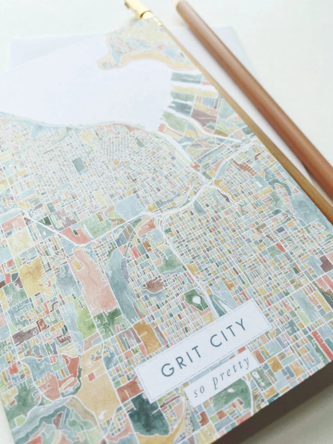 Colorful city map of Tacoma with 'Grit City so pretty' text on a white background