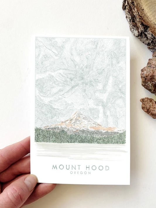 Postcard with a landscape painting of Mount Hood with a topographical drawing behind it. 