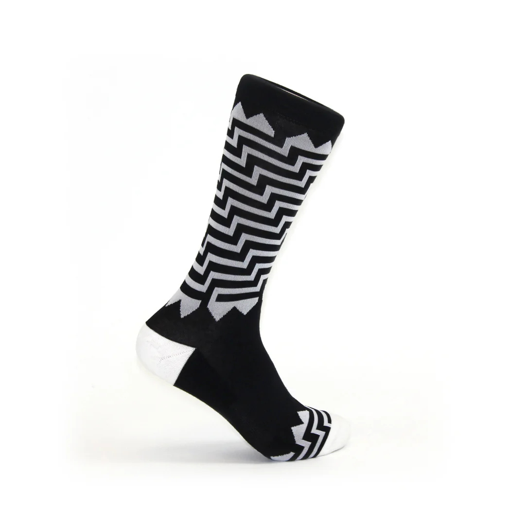 Black and white crew sock with a maze pattern design.