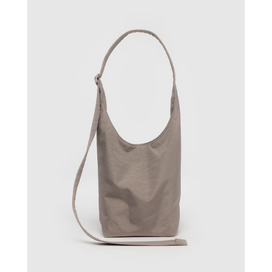 Beige nylon tote with a shoulder strap and a long strap.