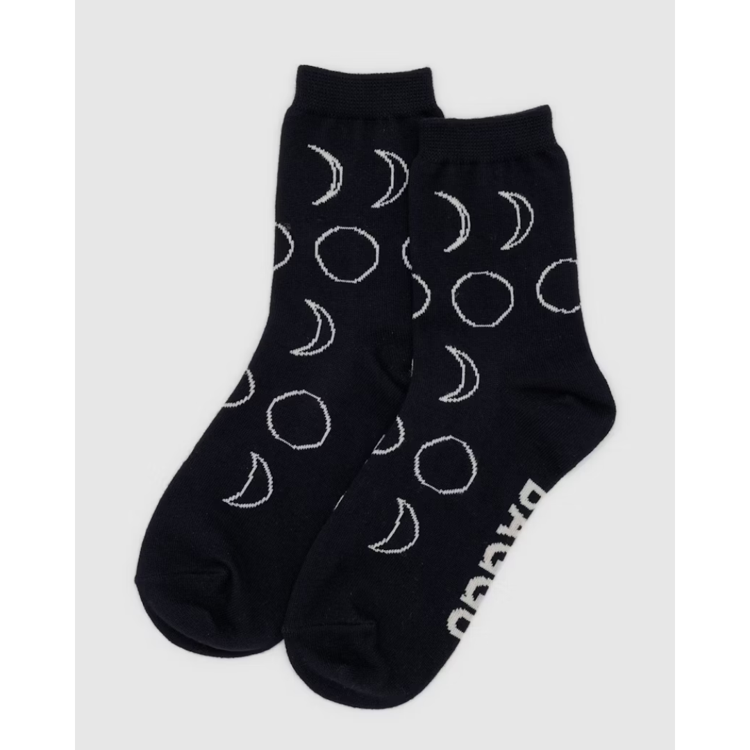 Black crew sock featuring white moons all over and the word "BAGGU" in white font on the bottom,