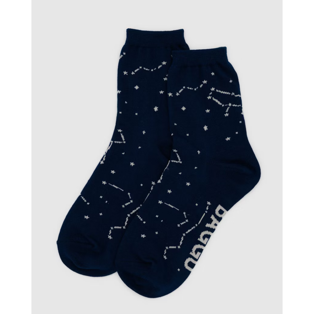 Navy blue crew sock featuring an all over constellation print in white and the word "BAGGU" in white on the bottom.