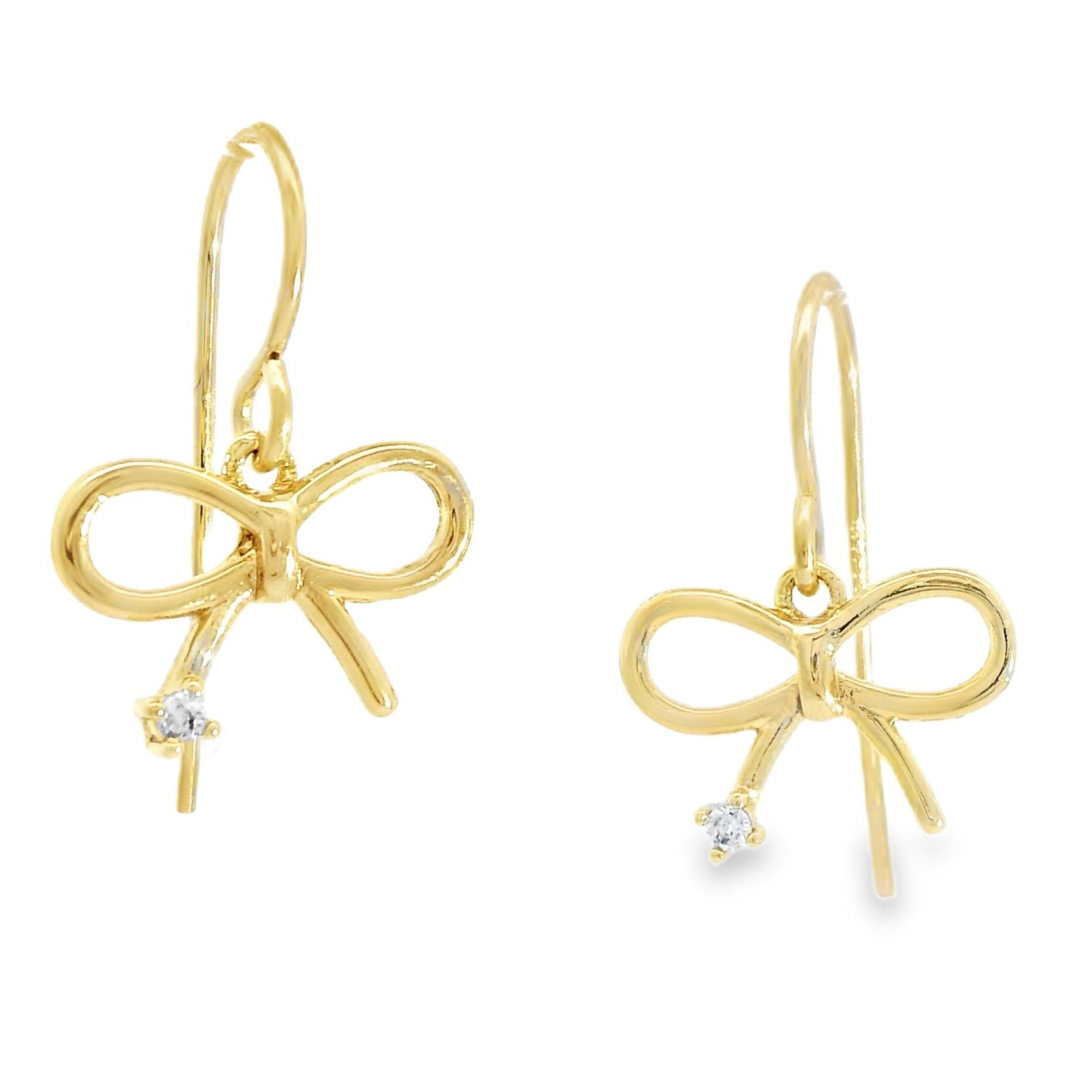 Gold bow shaped earrings featuring a  cubic zirconia stone at the bottom of each earring.