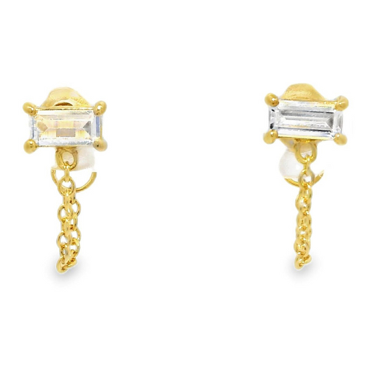 Gold accented huggie hoops featuring rectangular stones of cubic zirconia and dangly gold chains.