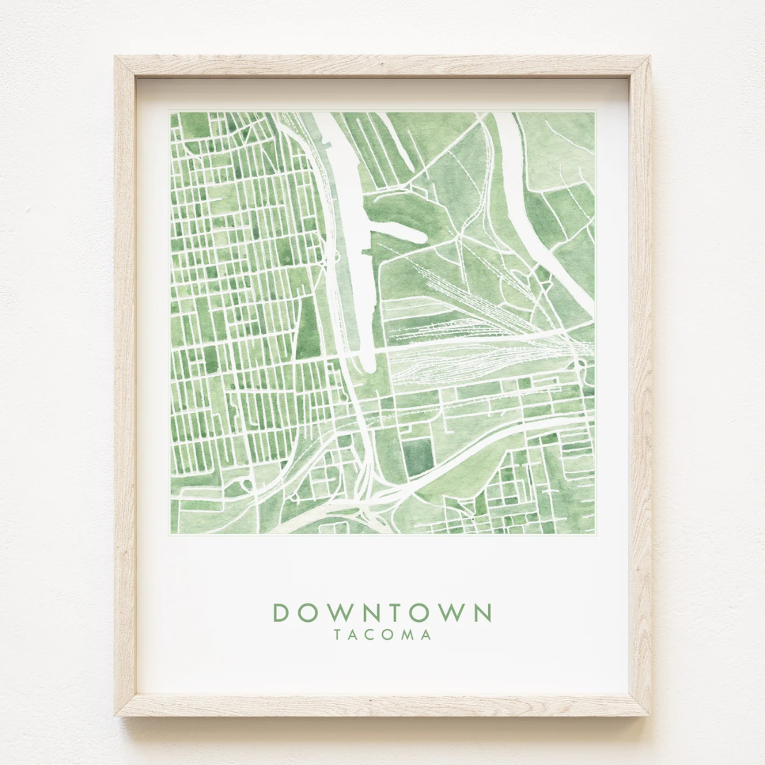 Framed map of downtown Tacoma painted print featuring several hues of green and the words "DOWNTOWN TACOMA" underneath.