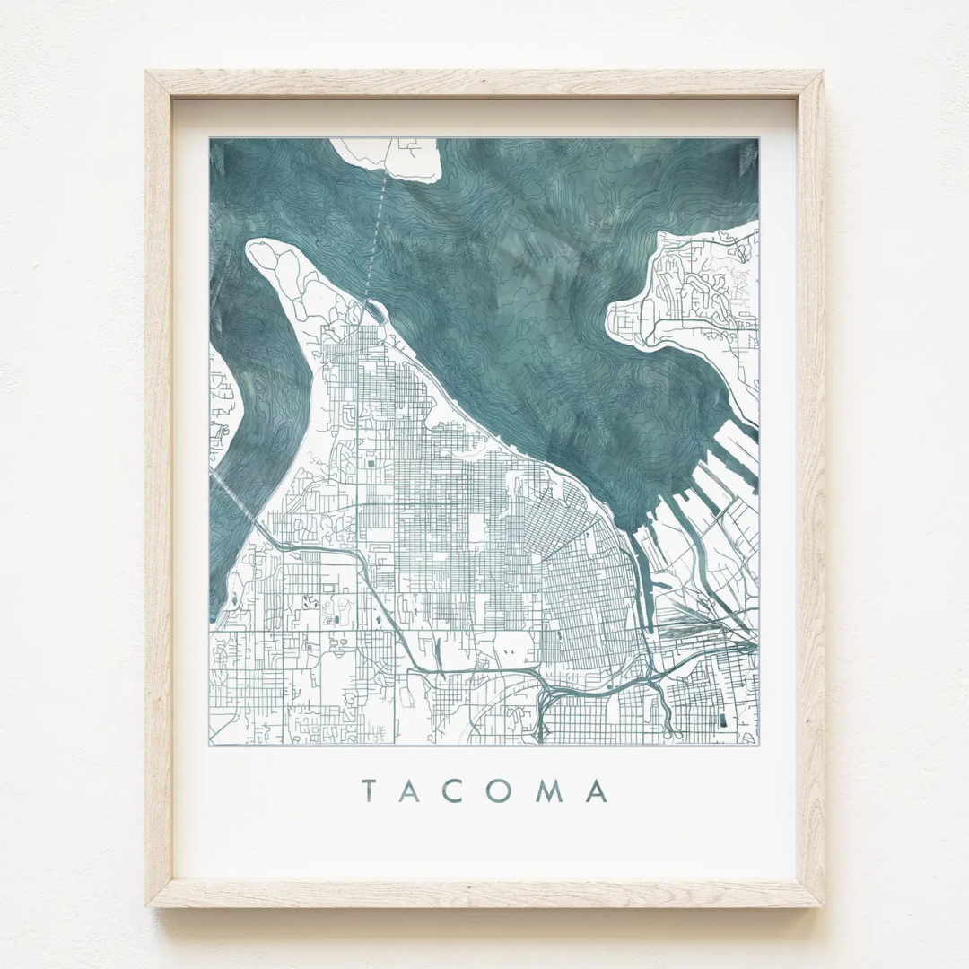 A watercolor map of the Puget Sound waters surrounding Tacoma and the peninsula in deep blue. Features the word "TACOMA" underneath.