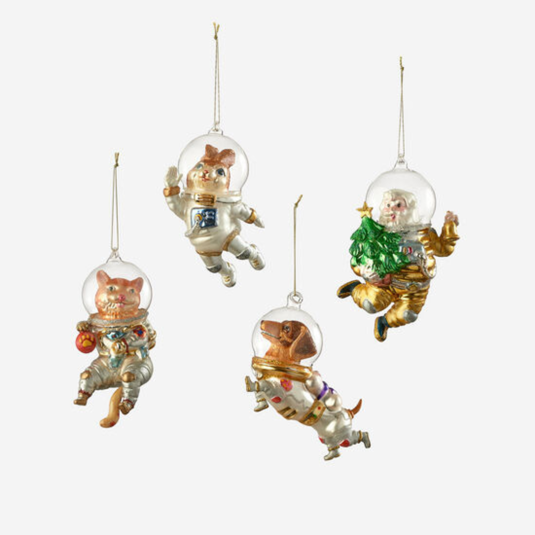 Holiday character ornaments featuring space helmets and holiday decorations.