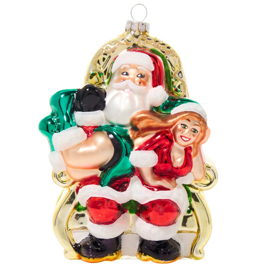 Ornament featuring Santa cozied up in his chair with Mrs. Claus dressed in red draped over his lap with his hand on her butt.