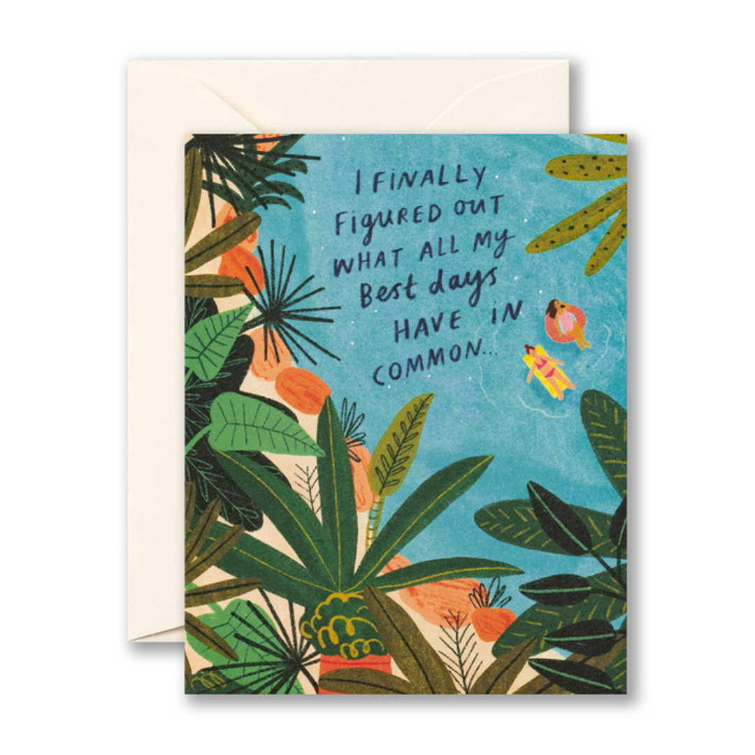 Greeting card featuring the words "I finally found out what all my best days have in common..." in dark blue writing over a lighter blue pool surrounded by green jungle leaves and two women in pink and yellow floaties in the pool.