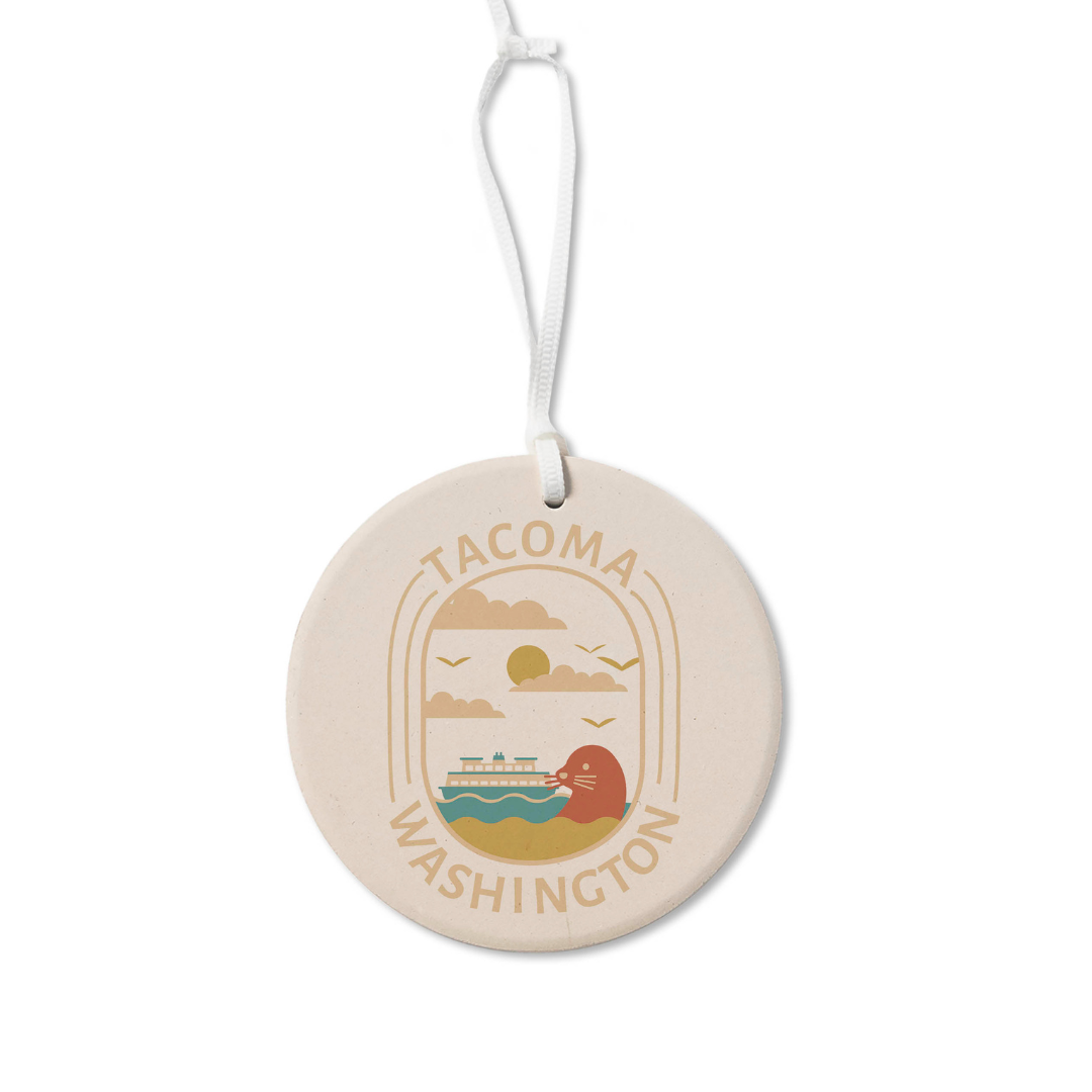 Round holiday ornament featuring the words "Tacoma, Washington" surrounding a seal and ferry boat floating in the waters of the Puget Sound.