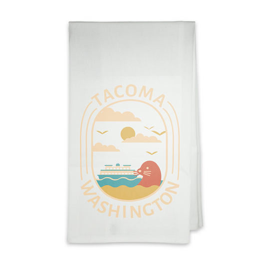 White tea towel features a classic Tacoma, Washington design of a seal and ferry boat floating in the blue waters of the Puget Sound.