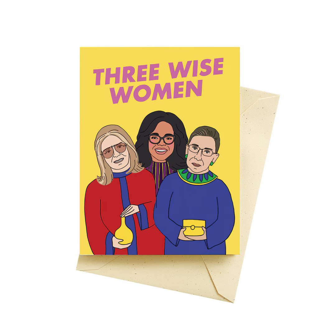 Yellow holiday card with the words "Three Wise Women" in pink letters above Gloria Steinem, Oprah Winfrey and Ruth Bader Ginsburg.