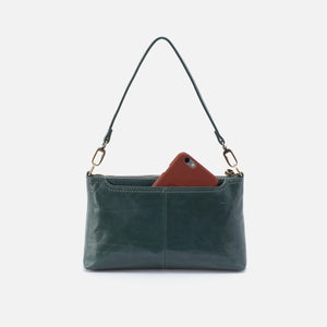 green leather bag back view pocket holding phone