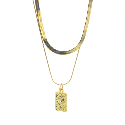 Pair of goldtone chains. Longer chain has a rectangular pendant with faceted clear stones