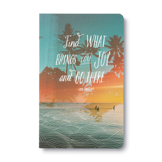 Notebook with beach scene and motivational quote on cover