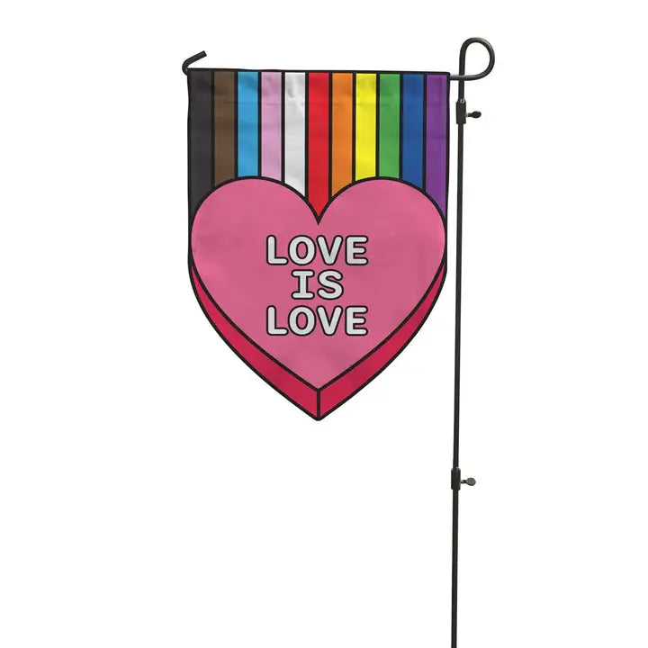 Garden flag with pride flag colors leading into pink heart that says "Love is Love" hanging from metal stand.