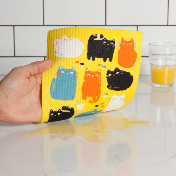 Sponge cloth being used to clean a spill