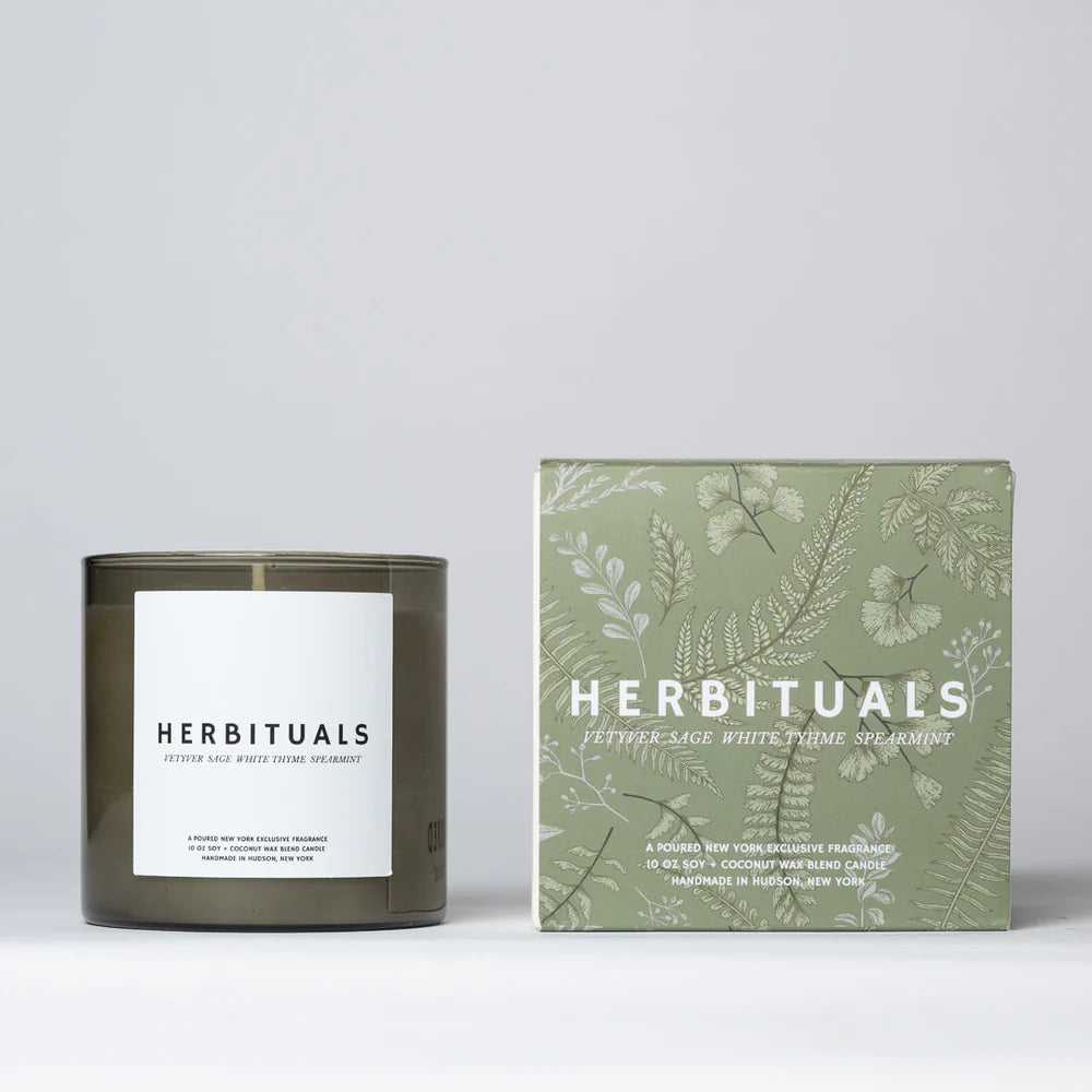 Herbituals candle with its box decorated with plant leaves