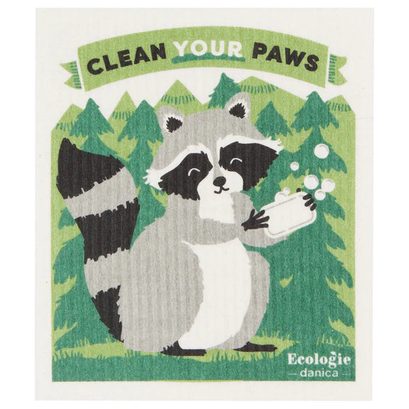 Reusable sponge cloth decorated with an adorable raccoon in the woods using a bar of soap with a banner that reads "Clean your paws"