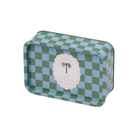 Blue and green checkered tin with a white label. Label has a palm tree on it and says "Paddywax, Lush PalmsSoy Wax Candle, 6.5 oz - 184 g