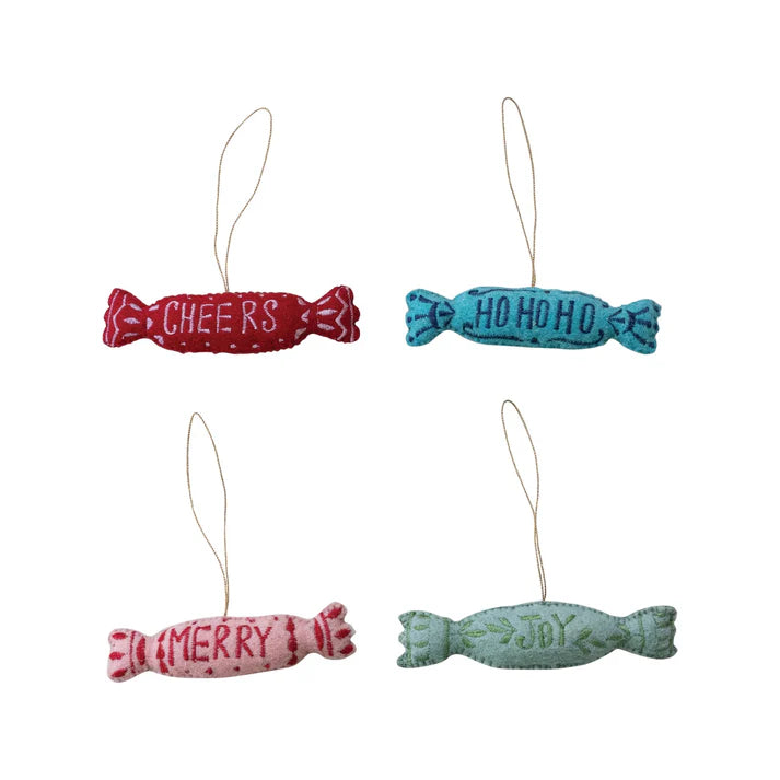 Four colorful candy-shaped ornaments- Red, Turquoise Blue, Pink, and Light Green, decorated with embroidery. Red says "Cheers" in white, Blue says "Ho Ho Ho" in dark blue, Pink says "Merry" in red, and Green says "Joy" in green.

Ornaments are sold individually and not as a set.
