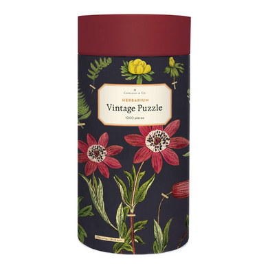 Cavallini round puzzle box with a deep red lid and navy case, adorned with vintage flowers.