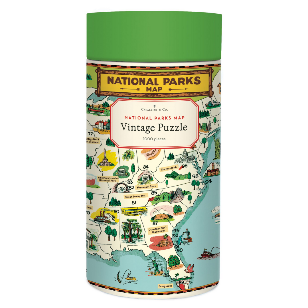 Cavallini round puzzle box with a green lid and cream case, adorned with a bright national parks illustration.