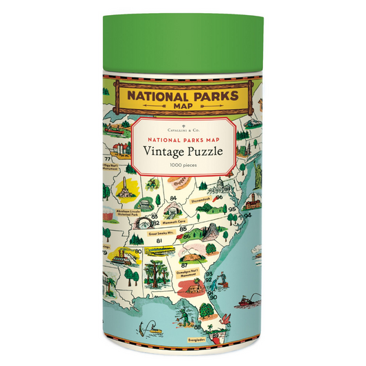 Cavallini round puzzle box with a green lid and cream case, adorned with a bright national parks illustration.