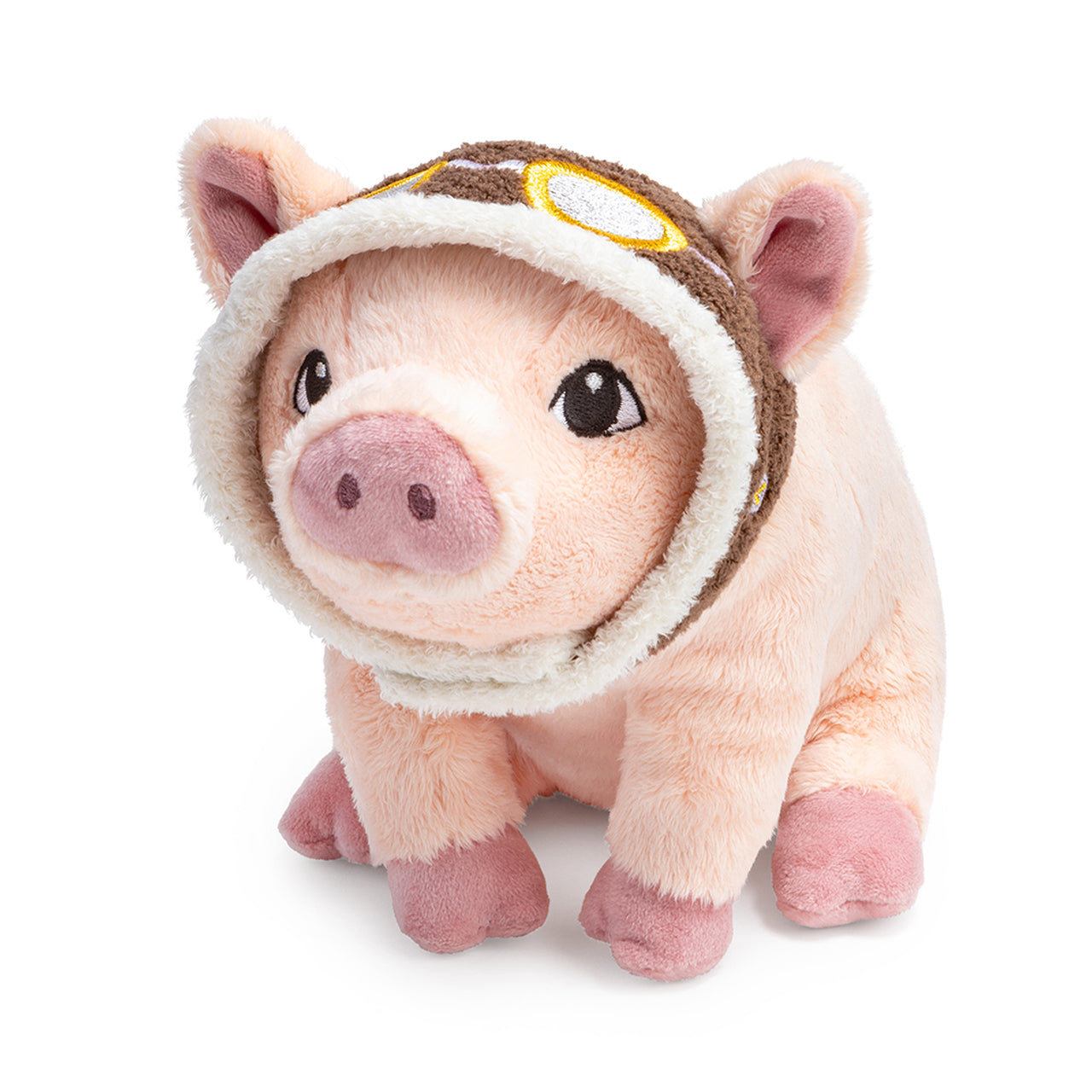 Plush toy pig wearing an airplane helmet on a white background