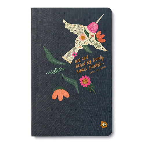 Notebook with floral design and motivational quote on a white background