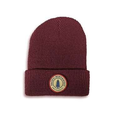 Maroon beanie with small patch featuring a tree and the text 